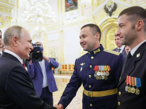 Russian President Vladimir Putin (L) congratulates the graduates of the Russian Higher military schools at the Kremlin in Moscow on June 21, 2023. (Photo by Gavriil Grigorov / POOL / AFP)